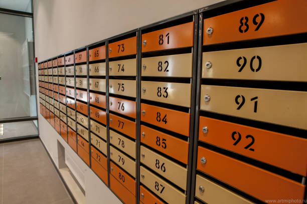 istock Row of metal yellow apartment mailboxes 1144856684