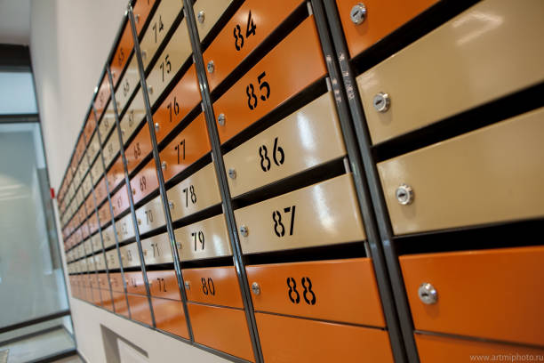 istock Row of metal yellow apartment mailboxes 1144856725
