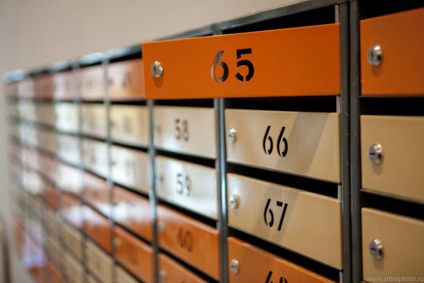 istock Row of metal yellow apartment mailboxes 1144856796