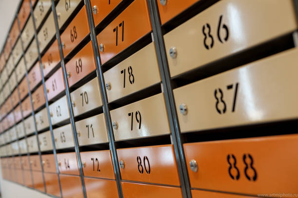 istock Row of metal yellow apartment mailboxes 1144857558