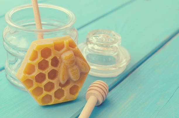 istock Honey and honey accessories for its use on a blue wooden background. 1144857761