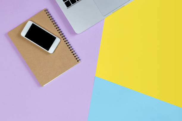 istock laptop background,Modern workplace with laptop, smartphone and copy space on color background. Top view Computers and Mobile on color full table background 1144857764