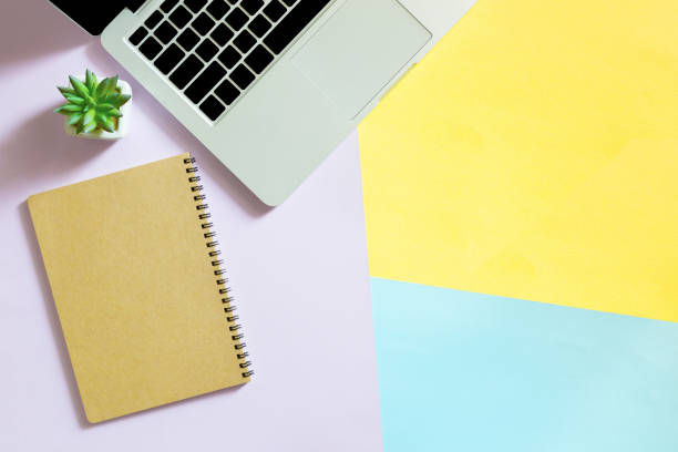 istock laptop background,Modern workplace with laptop, smartphone and copy space on color background. Top view Computers and Mobile on color full table background 1144857772
