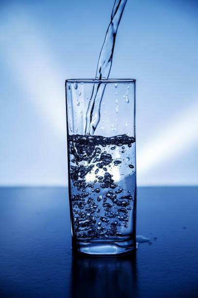 istock A glass of clean drinking water illuminated with blue light.. 1144858529