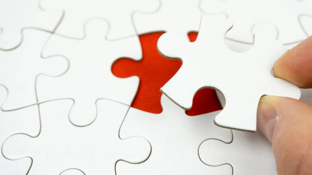 istock Hands placing last piece of a Puzzle 1144859507