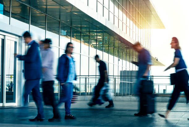istock People walking in front of a modern building. 1144859528