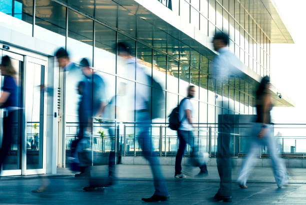 istock People walking in front of a modern building. 1144859543