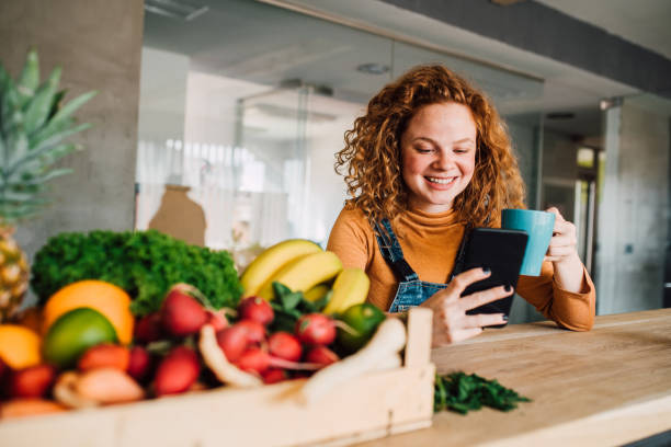 Woman drinking coffee and using mobile phone
