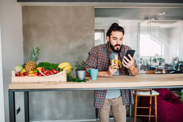 istock Student eating a banana and using mobile phone 1144859816