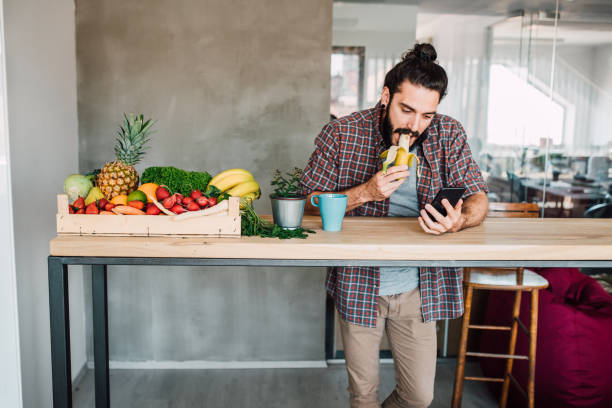 istock Student eating a banana and using phone 1144859817