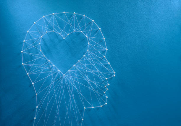 Developing emotional intelligence concept Learning to love concept. Network of pins and threads in the shape of a cut out heart inside a human head symbolising that love is the core of our being and has its own logic. psyche photography stock pictures, royalty-free photos & images