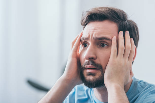 istock selective focus of frightened man with hands on head and copy space 1144864406