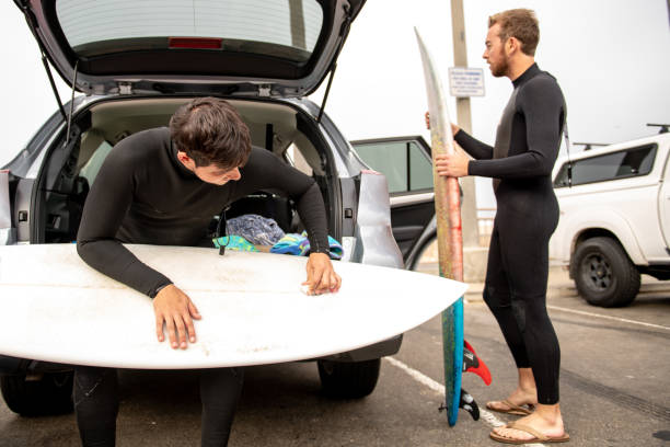 istock Two Surfers Prepare Near Their Car 1144865101