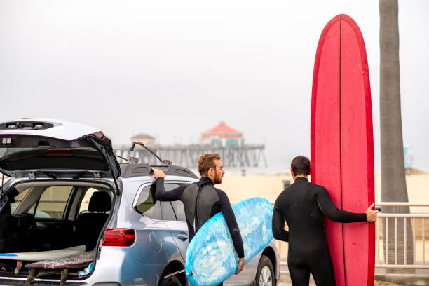 istock Surfers Stand Next to their Car and Check Out the Waves 1144865627