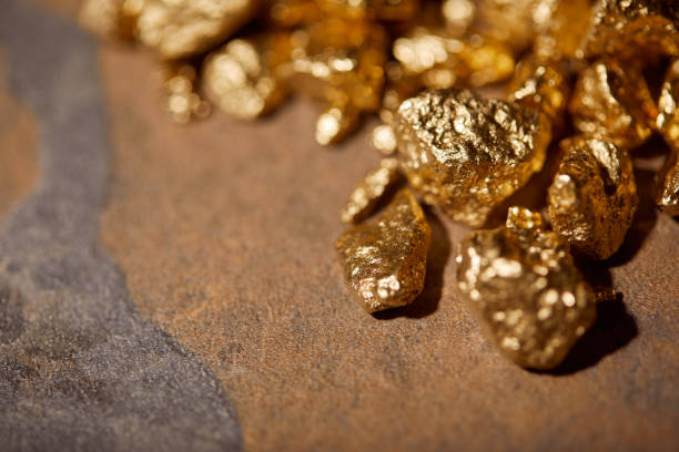 istock selective focus of golden stones on brown marble background 1144867399