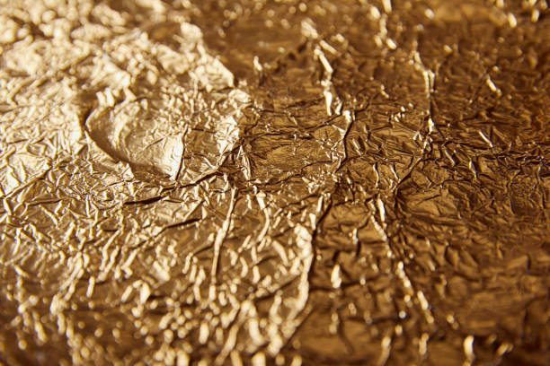 istock sheet golden foil with blurred bright glares 1144867564