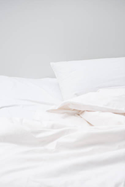 istock cozy bed with white pillows and blanket, with copy space 1144867614