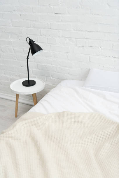 istock cozy bedroom with pillow on bed and lamp on stool 1144867694