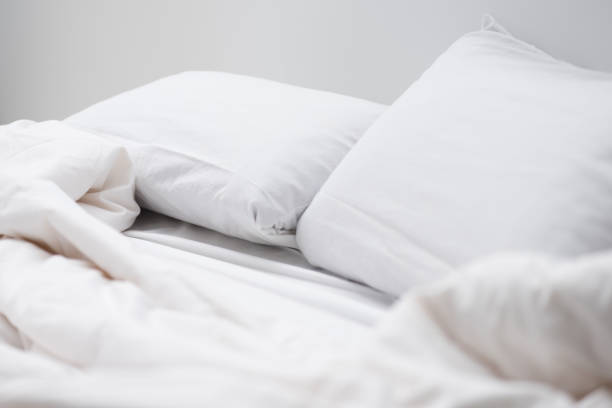 istock selective focus of empty bed with white pillows and blanket 1144867726