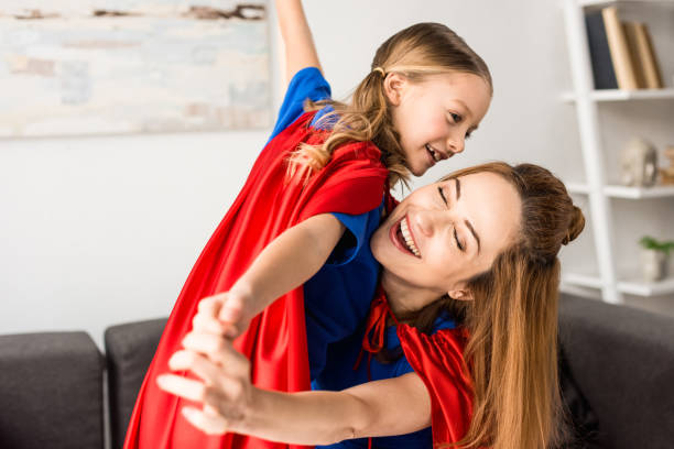 istock Smiling mother and cute kid playing at home 1144867980