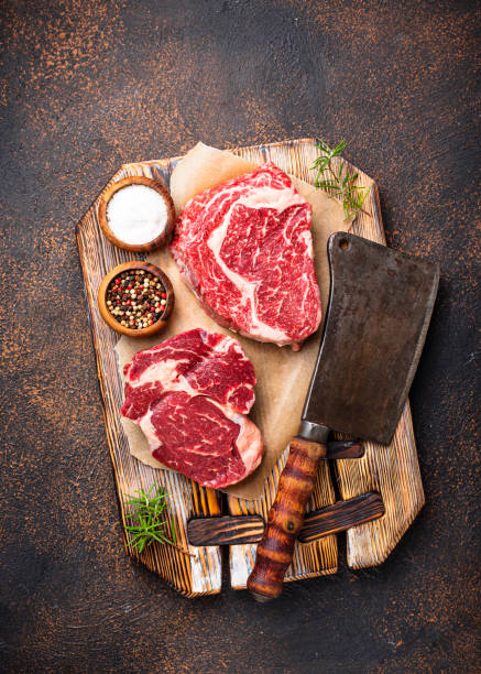 istock Raw marbled ribeye steak and butchers knife 1144869654