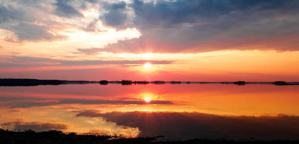 istock Sunset on the lake. Evening river. Sunset on the water horizon. 1144871045