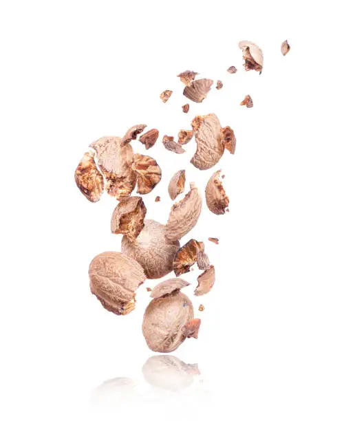 Nutmeg crushed in the air isolated on a white background