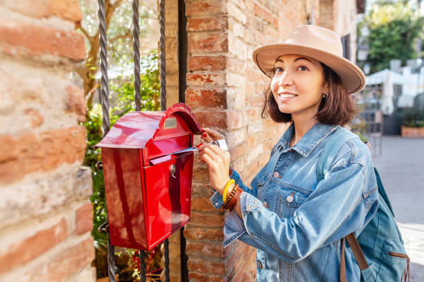 istock young asian woman sending letters using her mail post box 1144872514