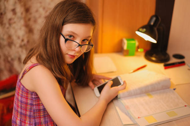 istock girl with glasses doing evening lessons 1144874018