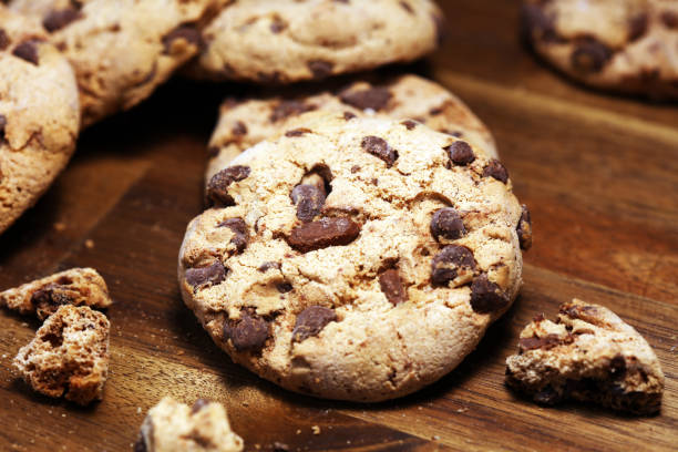istock Chocolate cookies on wooden table. Chocolate chip cookies 1144882009