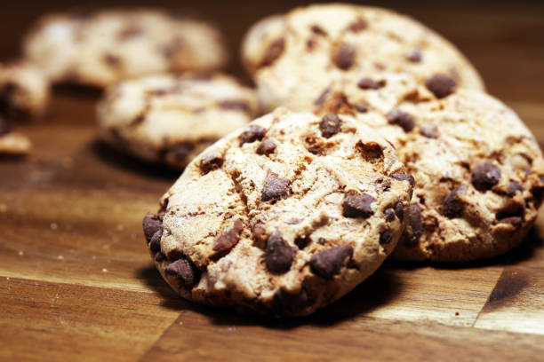 istock Chocolate cookies on wooden table. Chocolate chip cookies 1144882349