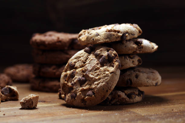 istock Chocolate cookies on wooden table. Chocolate chip cookies 1144882434
