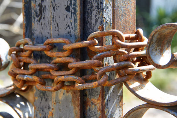 istock Different images of closed field fence with rusty chain 1144882705