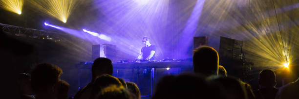 istock Dj playing techno music in the nightclub 1144883950