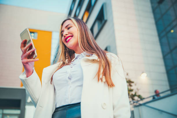 istock Businesswoman texting on mobile phone 1144886875