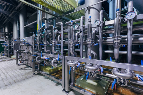 Industrial stainless steel pipes connected with vats and control valves Industrial stainless steel pipes connected with vats and control valves. stainless steel factory stock pictures, royalty-free photos & images