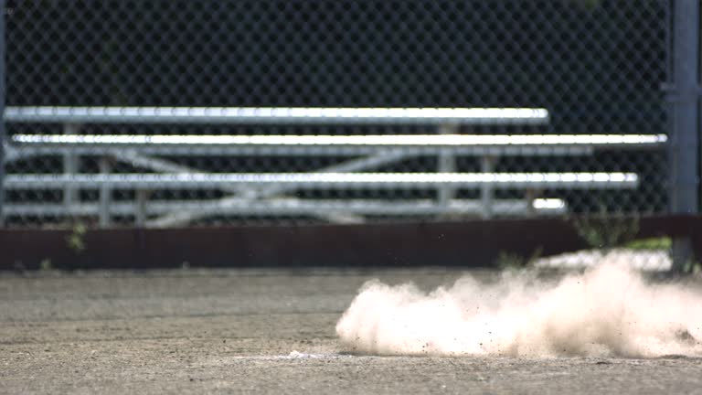 Baseball player slides into home base, slow motion