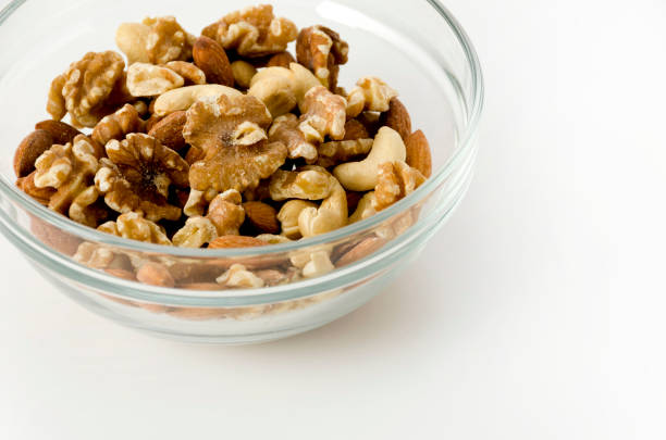 istock mix of nuts in a Stacking bowl on a white background. 1144896587