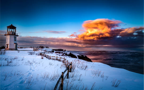 Source of light Cape of Percé Lighthouse at sunset, during the winter gaspe peninsula stock pictures, royalty-free photos & images