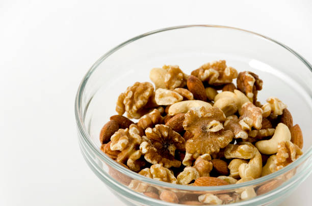 istock mix of nuts in a Stacking bowl on a white background. 1144898756