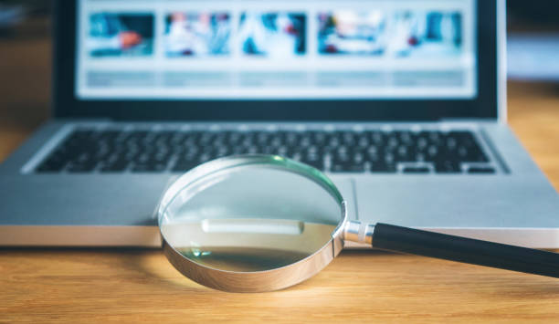 istock Magnifying glass and laptop 1144905121