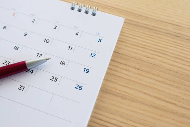 istock calendar page with pen on wood table background 1144910211