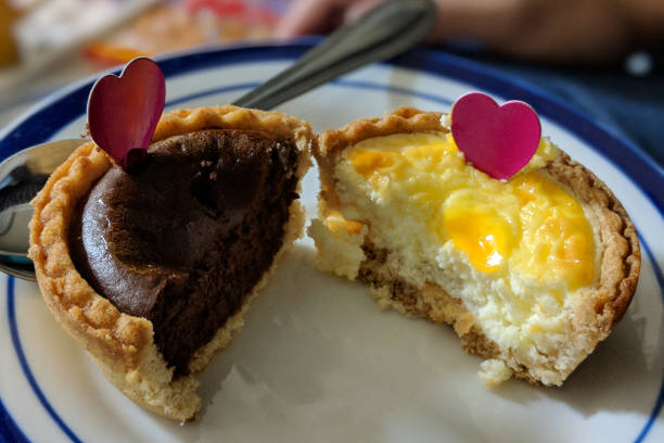 Baked cheesecake dessert halves decorated with pink hearts