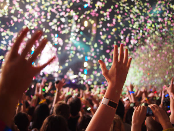 Hands waving in the crowd at music concert