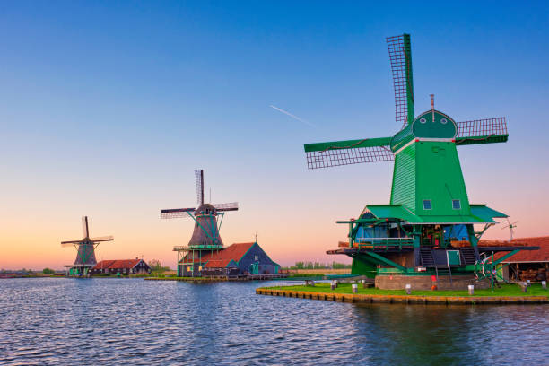 Windmills at Zaanse Schans in Holland on sunset. Zaandam, Netherlands stock photo
