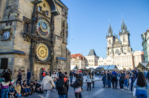 The famous astronomical clock and the Tyn church in Prague on a sunny day