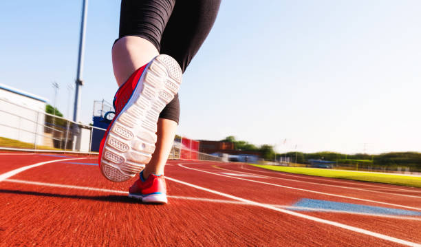 istock Woman jogging on a running track 1144922737