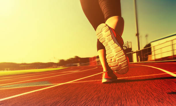 istock Woman jogging on a running track 1144922742