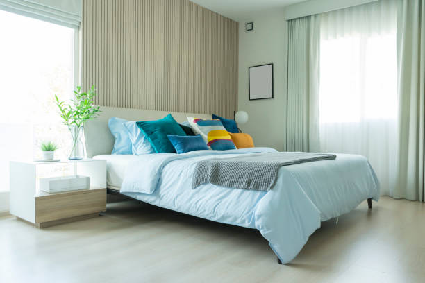 istock Clean modern bedroom with blue and yellow cushion setting on it. 1144926832