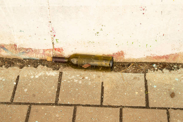 istock Empty wine bottle lying on the street - background 1144926837